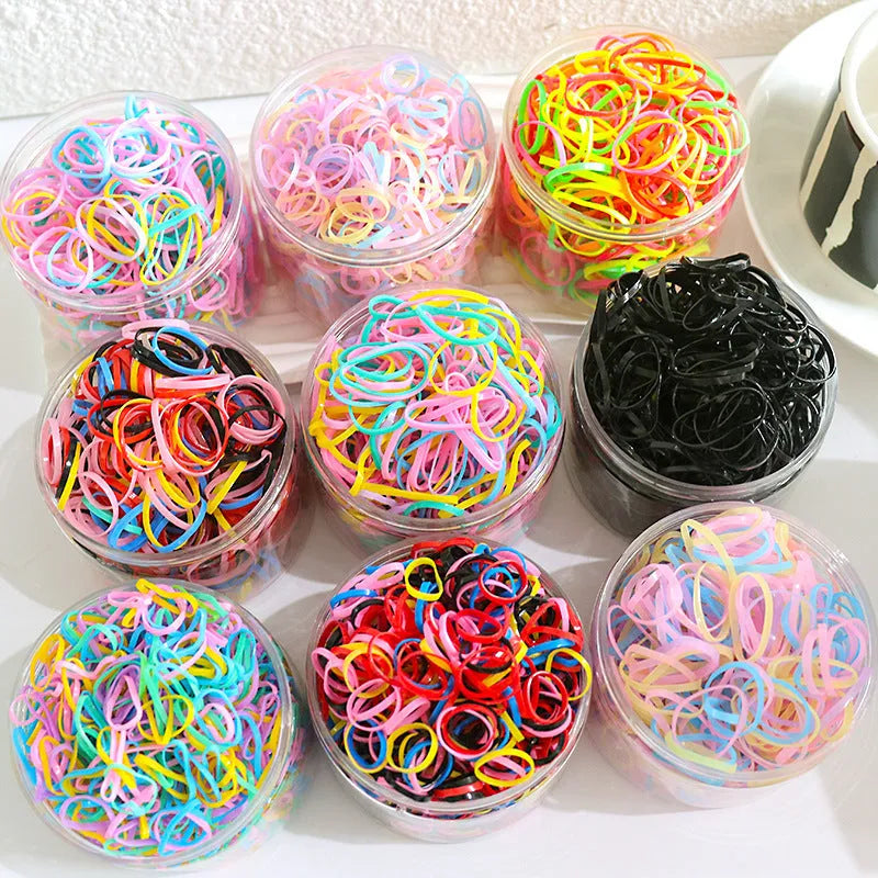 Multicoloured TPU baby hair ties in a reusable transparent storage container
