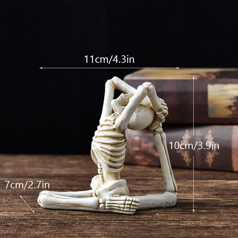 A detailed resin desktop ornament of a yoga-pose skeleton skull in black and white colour options.