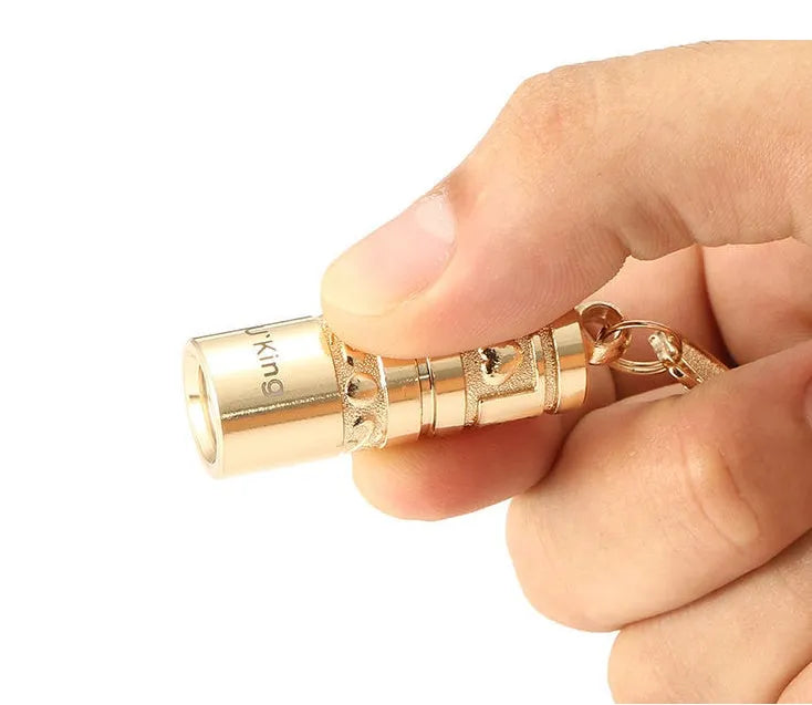 Gold zinc alloy waterproof mini LED flashlight on a keychain ring