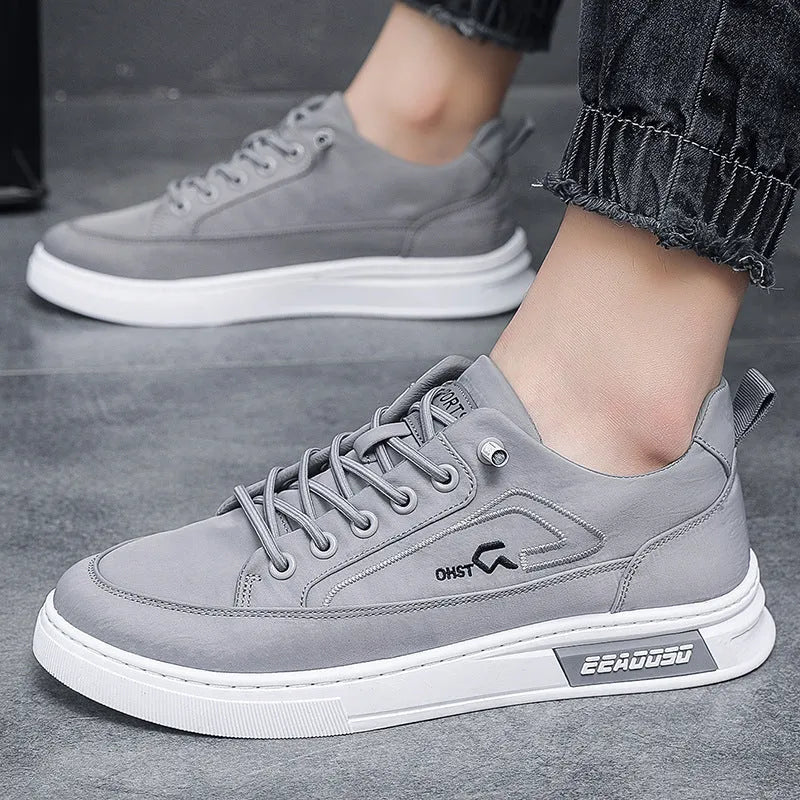 Grey men's low-top canvas casual sneakers with lace-up front and round toe on a rubber sole.