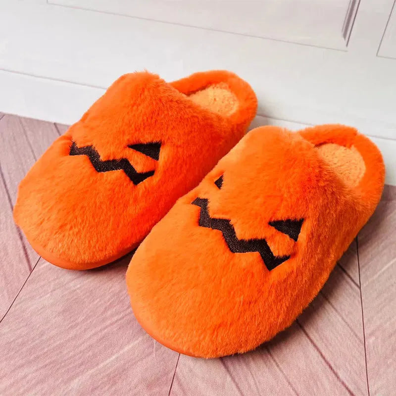 Orange Halloween pumpkin slippers with plush lining and a textured non-slip PVC sole.