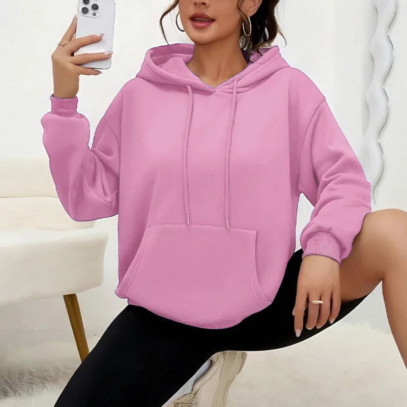 Women's loose grey drawstring hood sweatshirt with a front kangaroo pocket on a hanger.