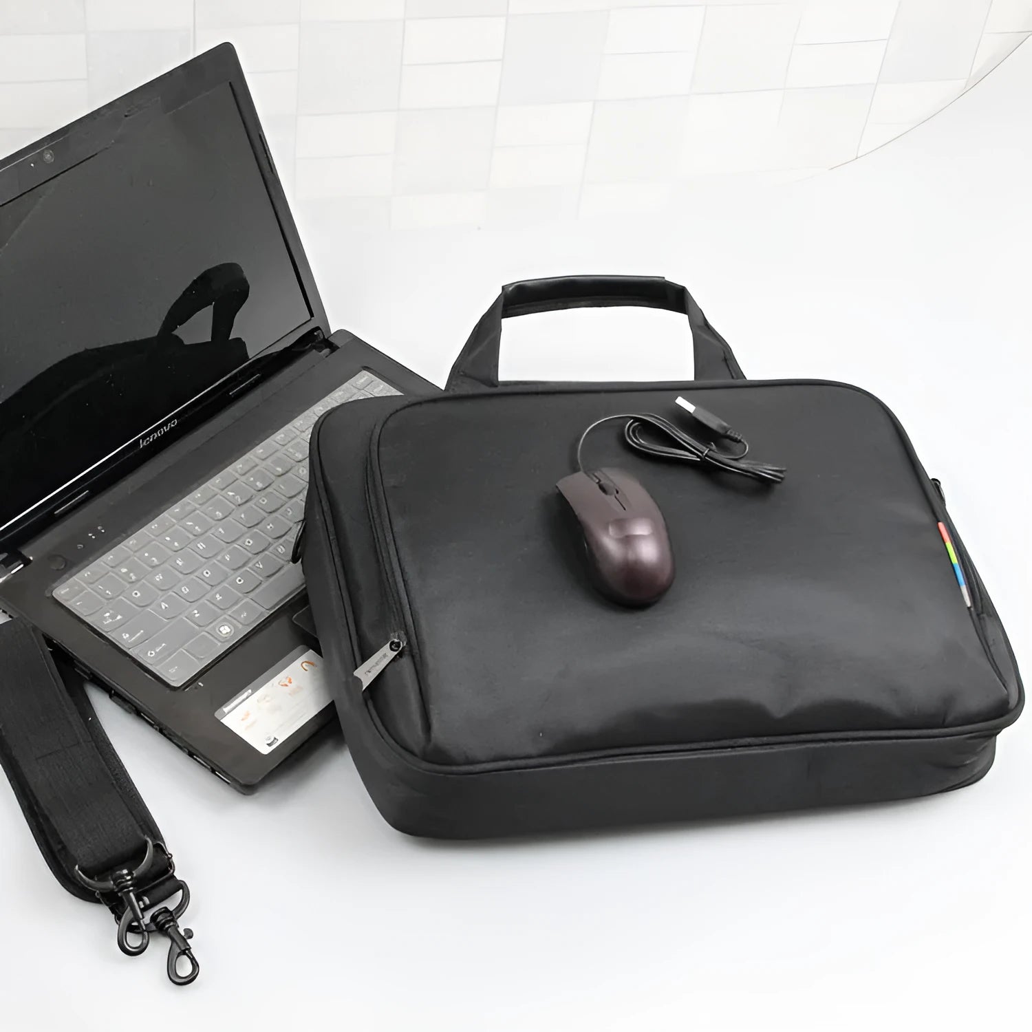 Black one-shoulder nylon computer bag with water repellent finish and hidden non-slip strap for 14-inch laptops