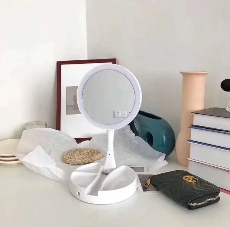 White foldable LED vanity mirror with storage compartments and USB charging port