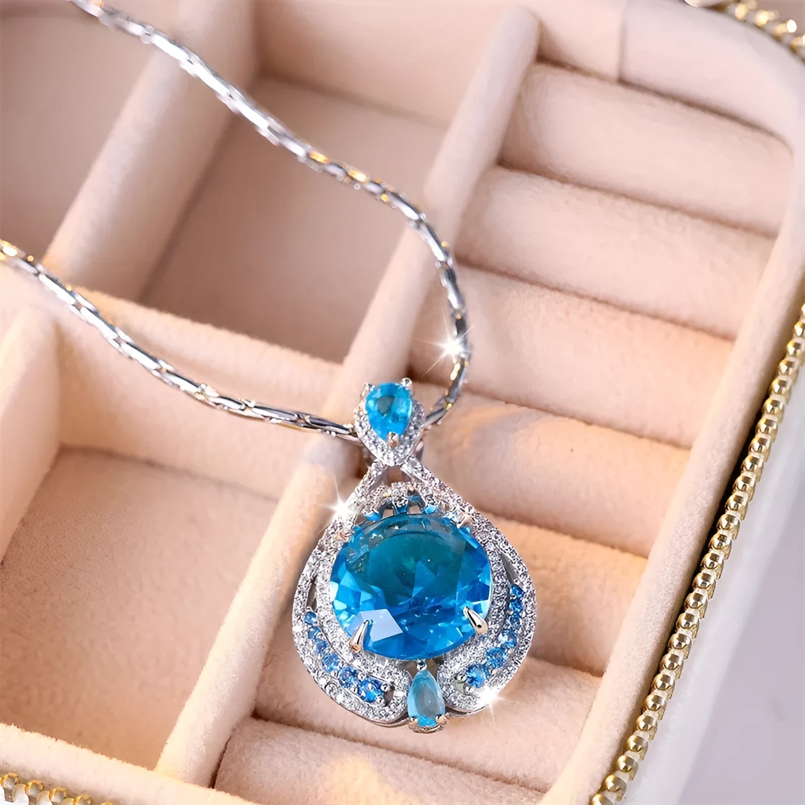 Geometric pendant necklace with blue fireworks cut gemstones on water wave chain