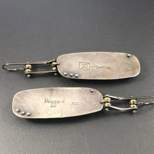 A pair of geometric-shaped fashion earrings with a two-colour marble pattern, made from alloy metal.