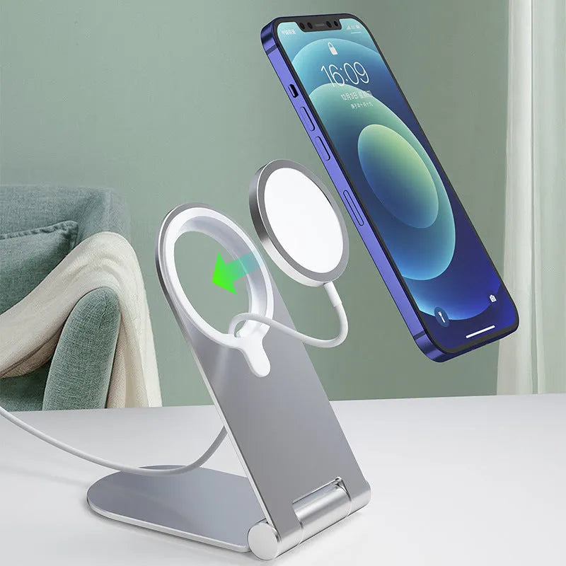 Silver vertical aluminium alloy magnetic phone bracket for iPhone 12 on a table.