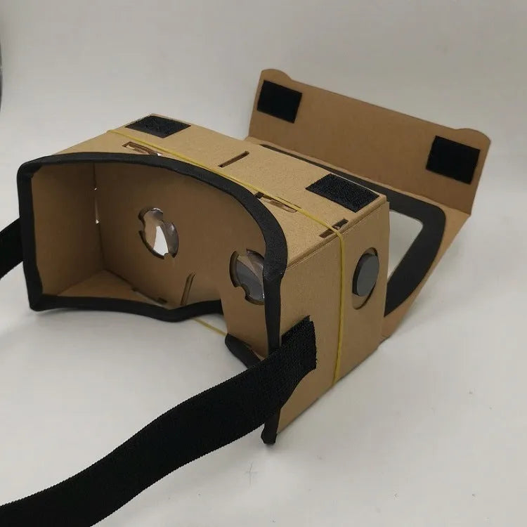 Pink and white VR Cardboard Glasses headset for 6-inch smartphones on a table.