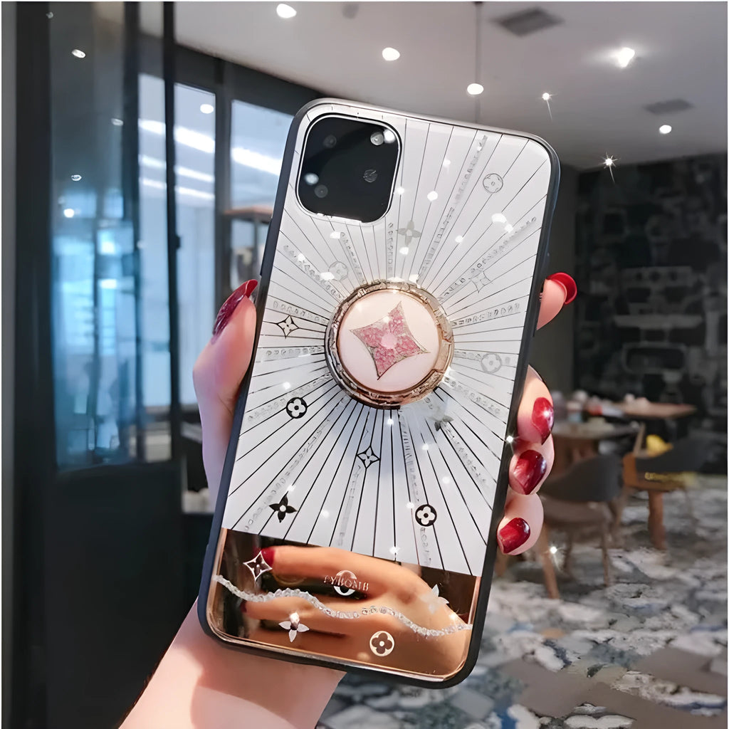 Gold metal iPhone ring stand with diamond detail on the back of a phone