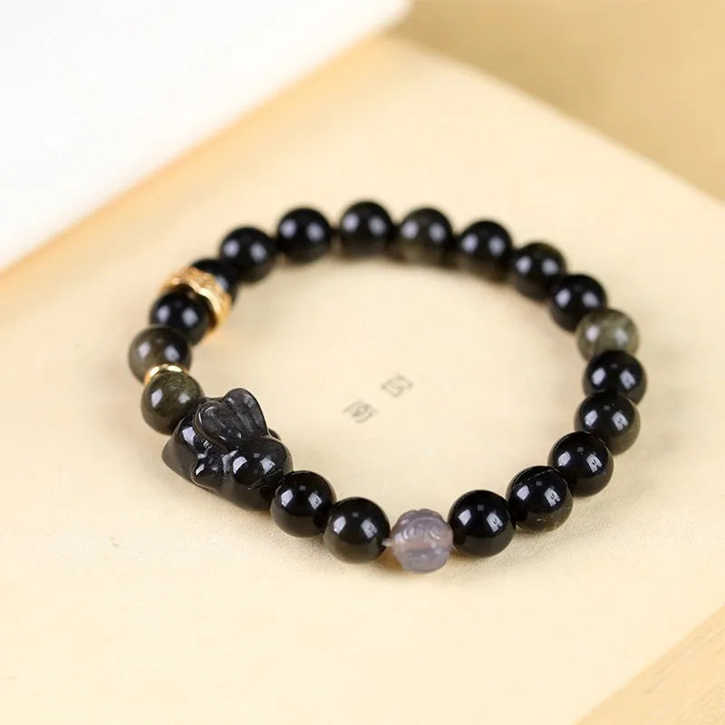 Handmade lying rabbit obsidian bracelet with Jin Yaoshi and brass beads, available in 8mm and 10mm sizes.