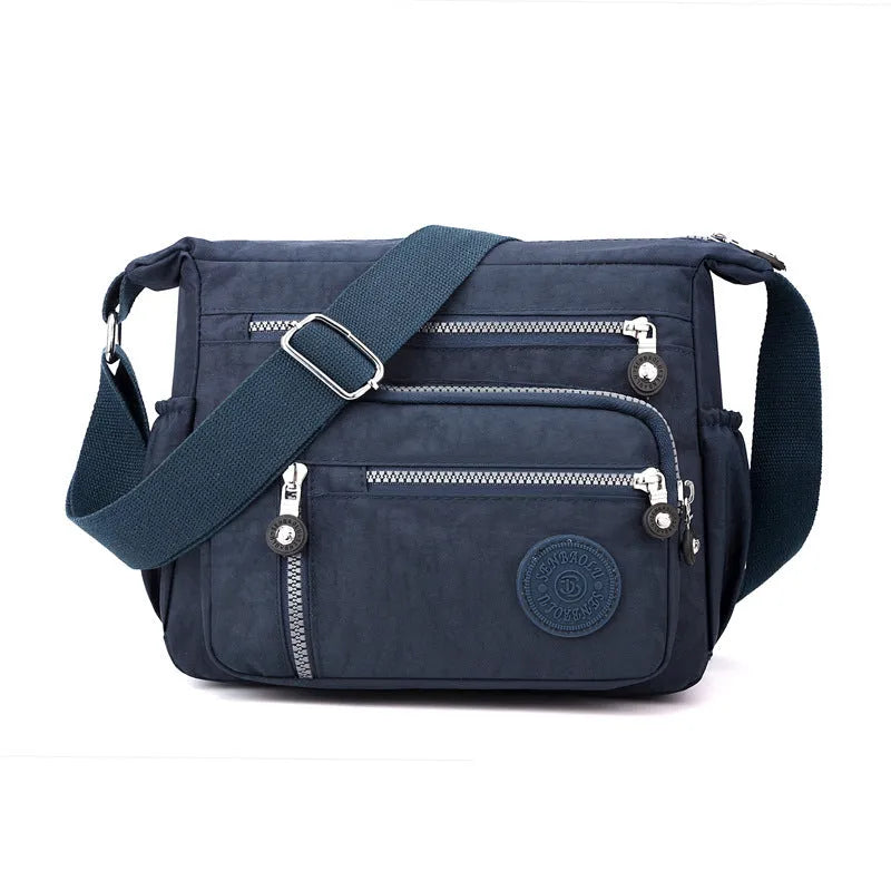 Grey square vertical nylon messenger bag with a single shoulder strap shown open.