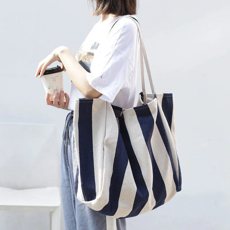 Striped canvas shoulder bag in black, blue, or red with 39cm bottom length, 35cm height, 21cm thickness, and certificate bag.