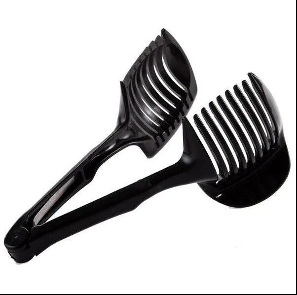 A black or green plastic tomato slicing holder on a kitchen worktop.