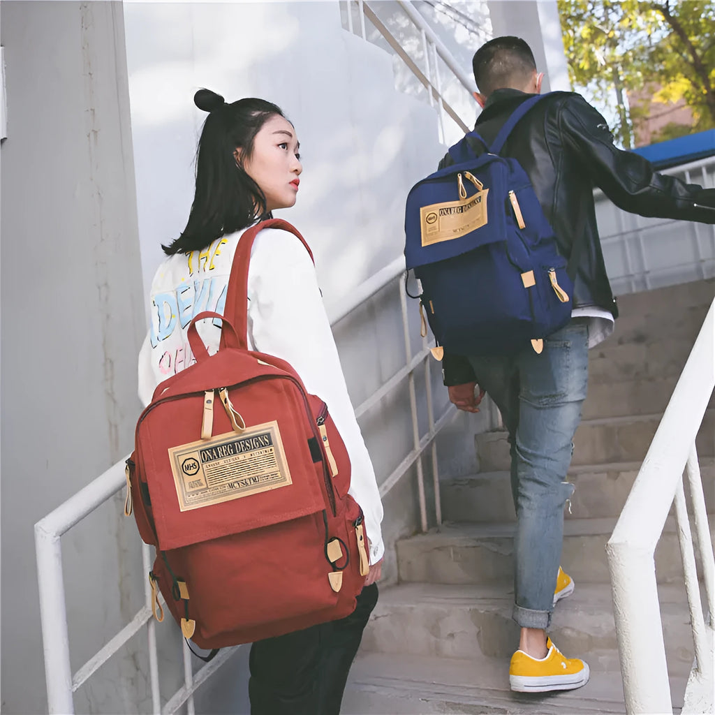 Korean canvas backpack in black with rain cover, double shoulder straps, and zipped internal pockets for travel and campus use