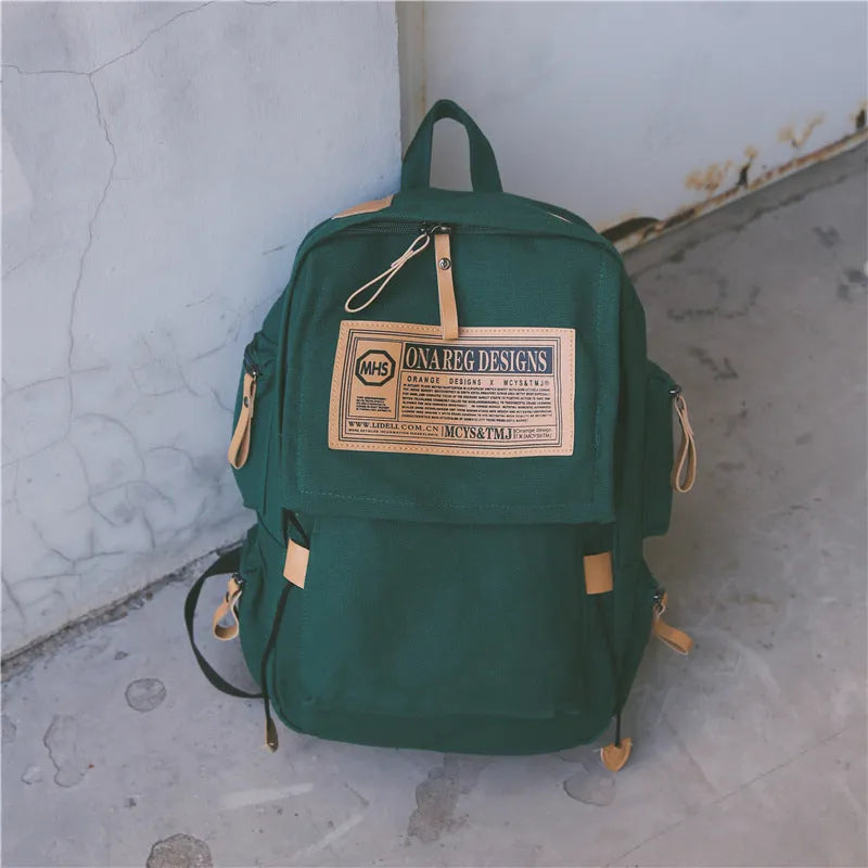 Korean canvas backpack in black with rain cover, double shoulder straps, and zipped internal pockets for travel and campus use
