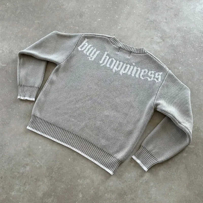 Grey loose-fitting long sleeve knitwear coat on a hanger.