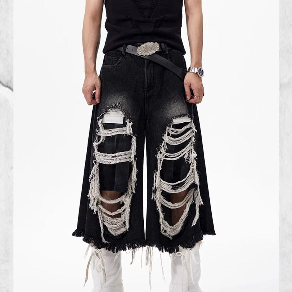 Black cropped wide-leg women's jeans with ripped patches on the knees.