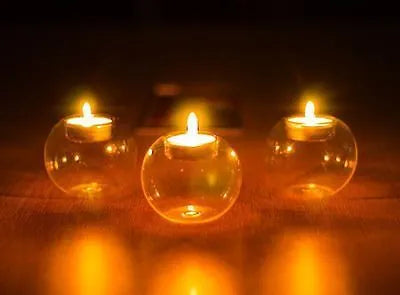Handmade round clear glass candle holder on a table