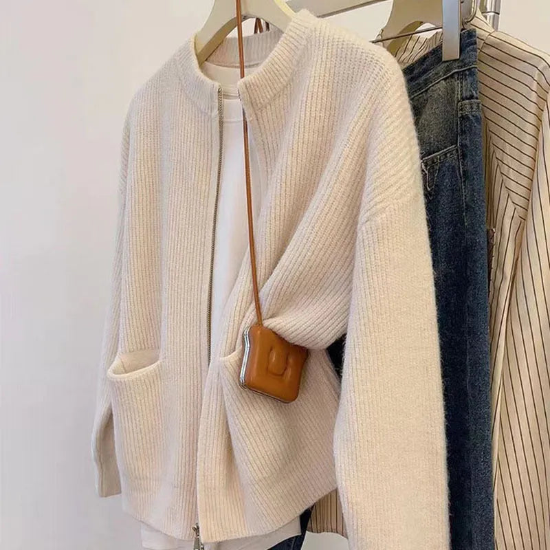Beige soft viscose long sleeve sweater coat cardigan on a hanger.