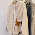 Beige soft viscose long sleeve sweater coat cardigan on a hanger.