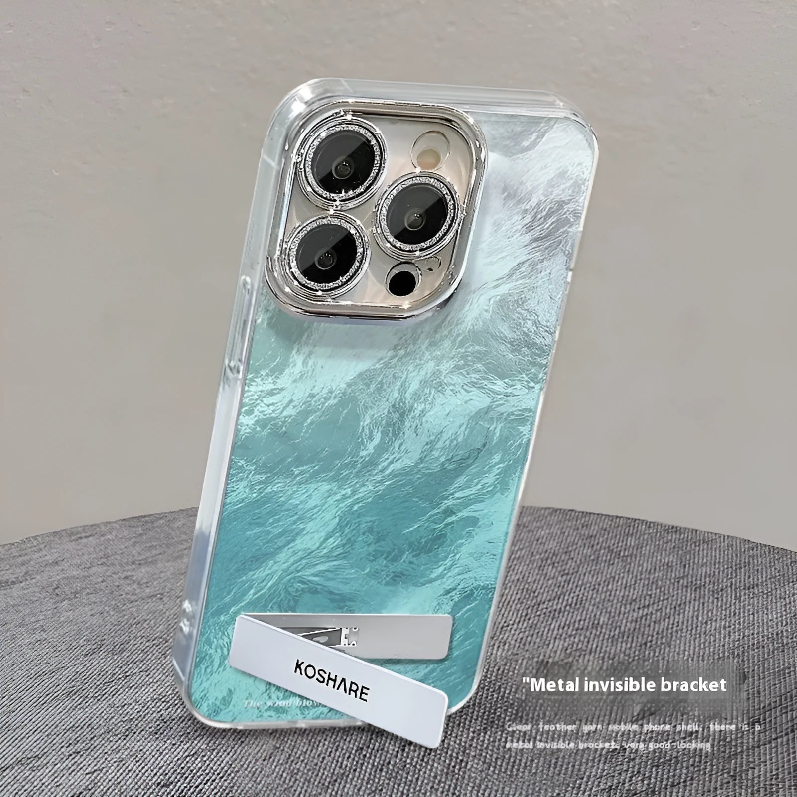 Ice blue gradient hard PC phone case with invisible bracket and silver chain for iPhone set on a white surface
