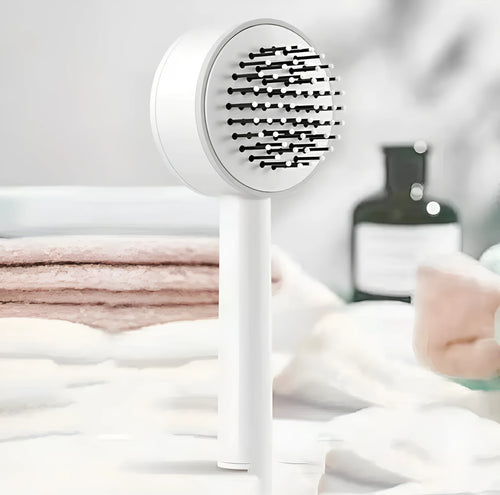 Plastic air cushion comb with long handle in white, green, and pink colours for hair detangling and styling