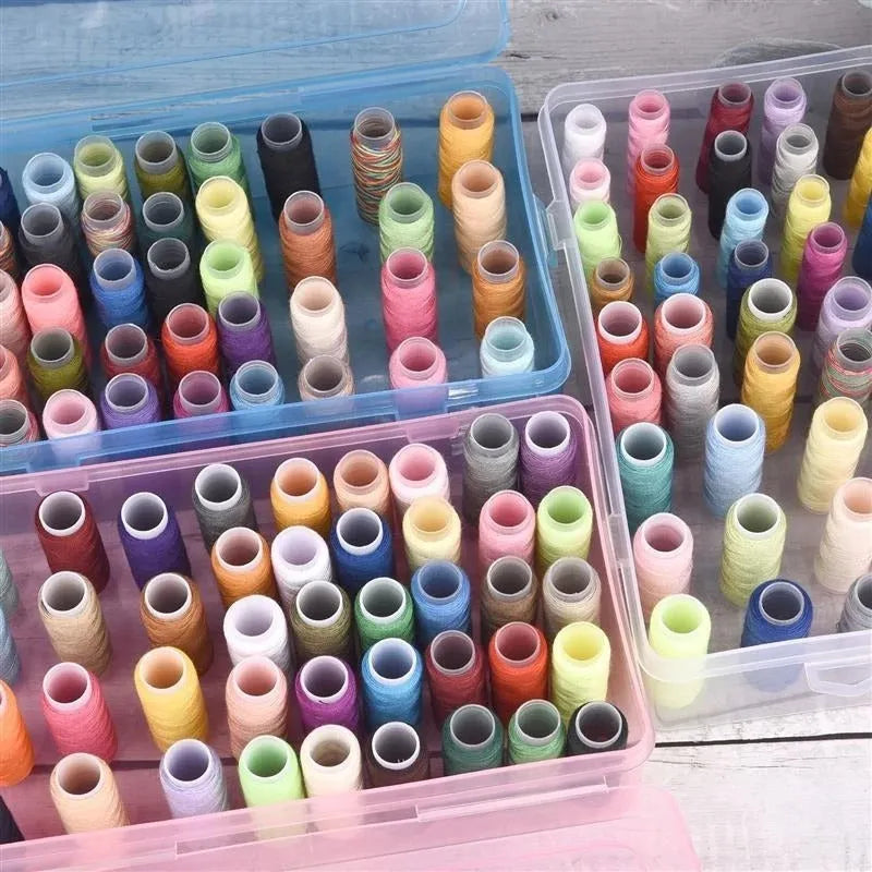 A transparent, pink, or blue plastic storage box with 42 small compartments for embroidery threads and craft supplies.
