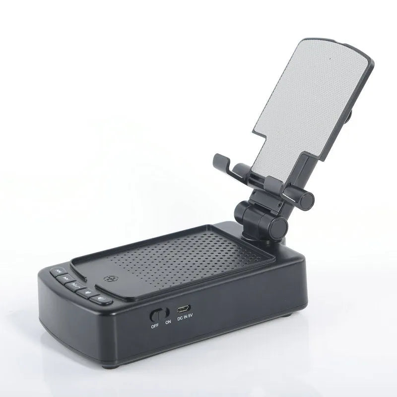 Multifunctional plastic tablet and phone holder with audio in black on a desk