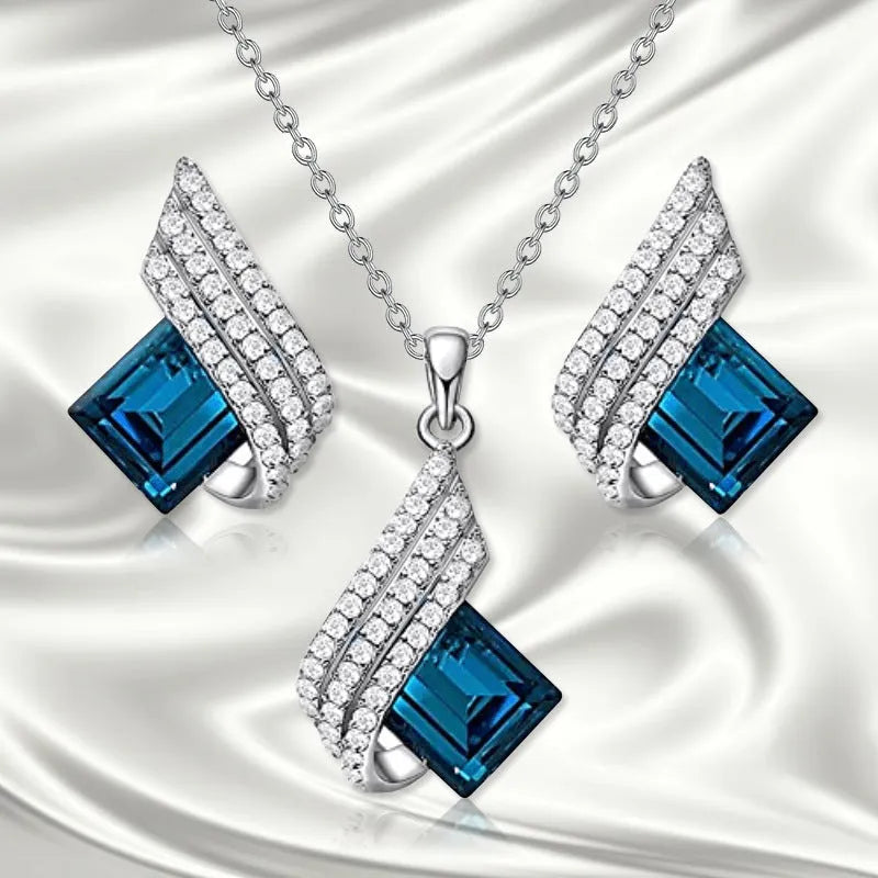 Alloy pendant necklace and matching earrings with glass ornamentation and cross chain design