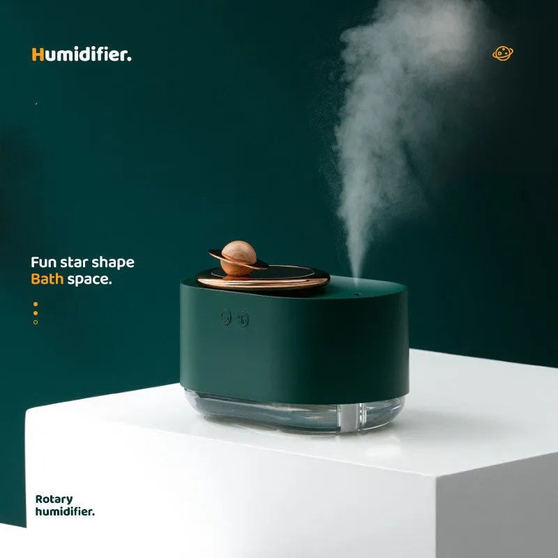 Green rotating planet-shaped USB humidifier with night light on a wooden desk