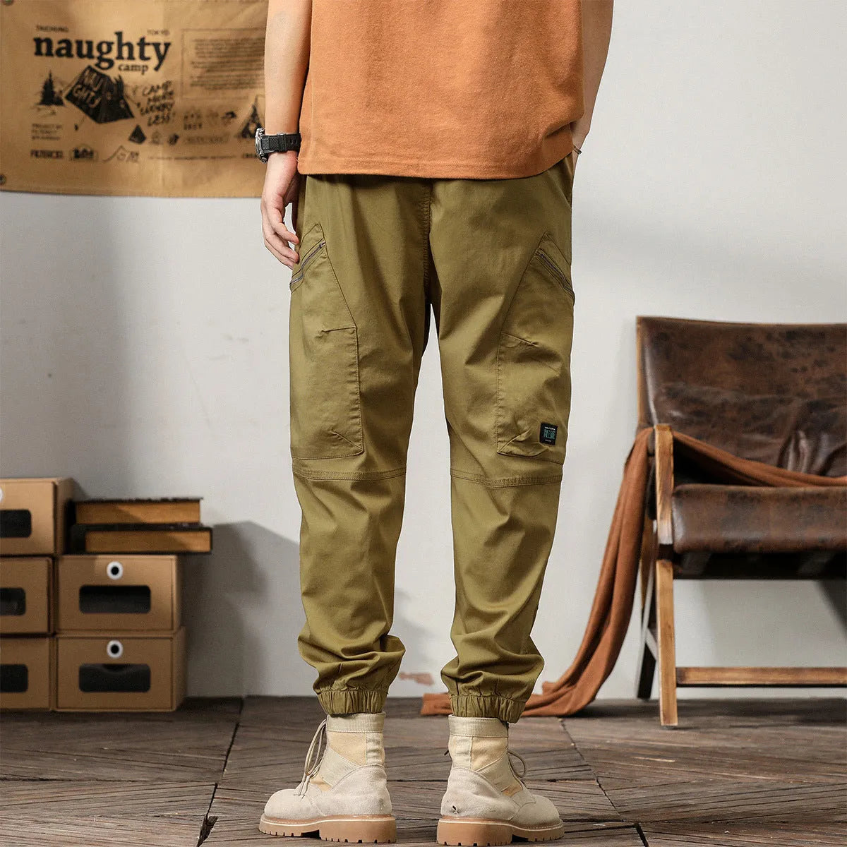 Men's khaki cotton tapered harem pants with a small ankle opening and mid-waist design on a neutral background.