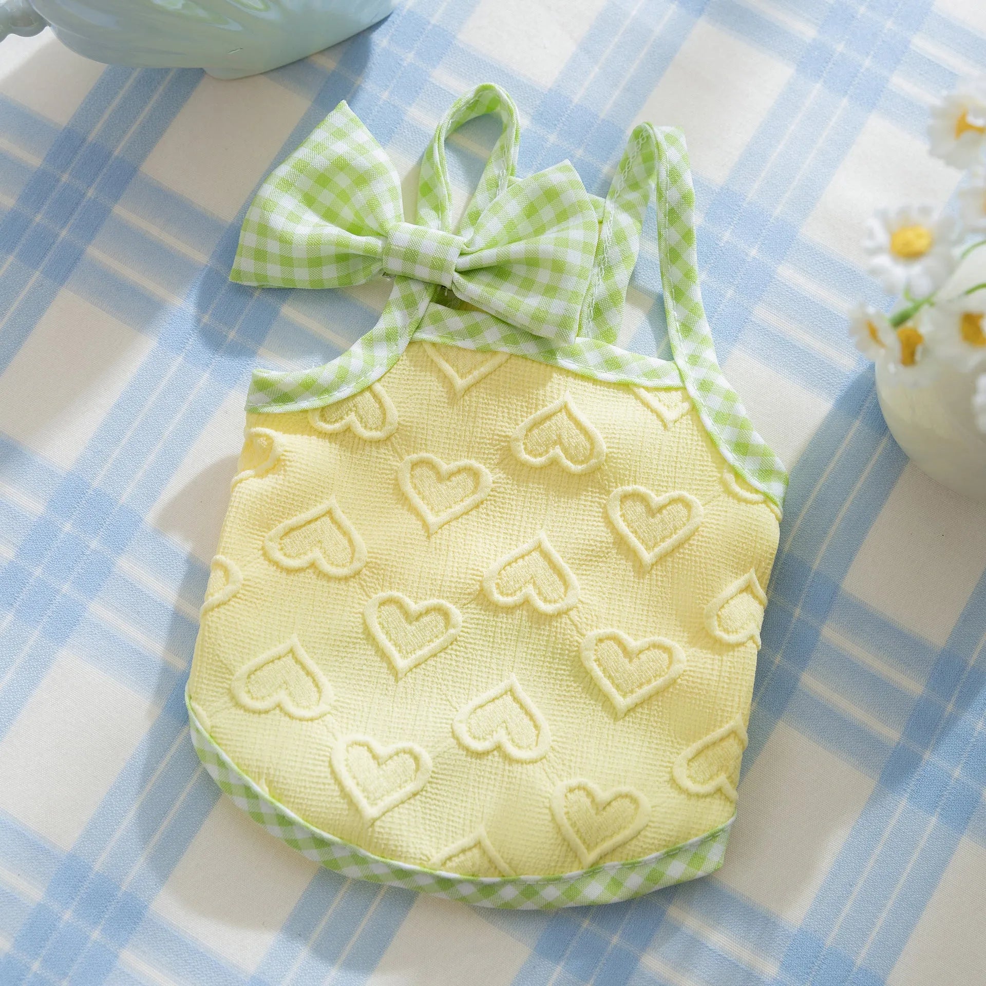 Small dog wearing heart texture vest with bow suspenders in Bondi Blue