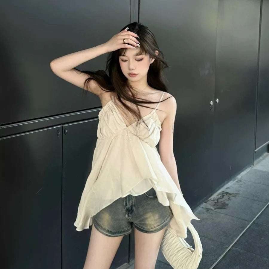 Apricot polyester sleeveless vest top with spaghetti straps, double-connector strap style, and asymmetric splicing detail.