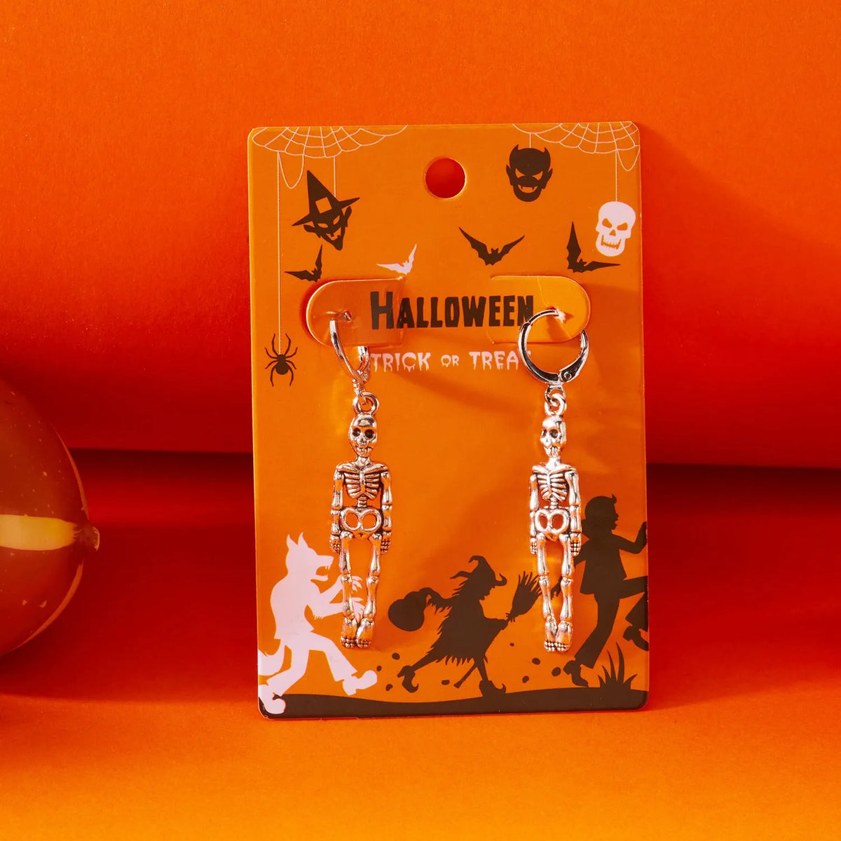 Long skull fringe earrings in electroplated alloy with pumpkin skull charm, women's dangle style, one pair