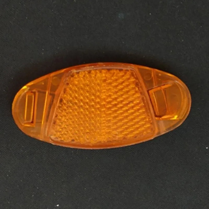 White and yellow plastic bicycle reflector spoke decorations measuring 7.2cm by 3.5cm