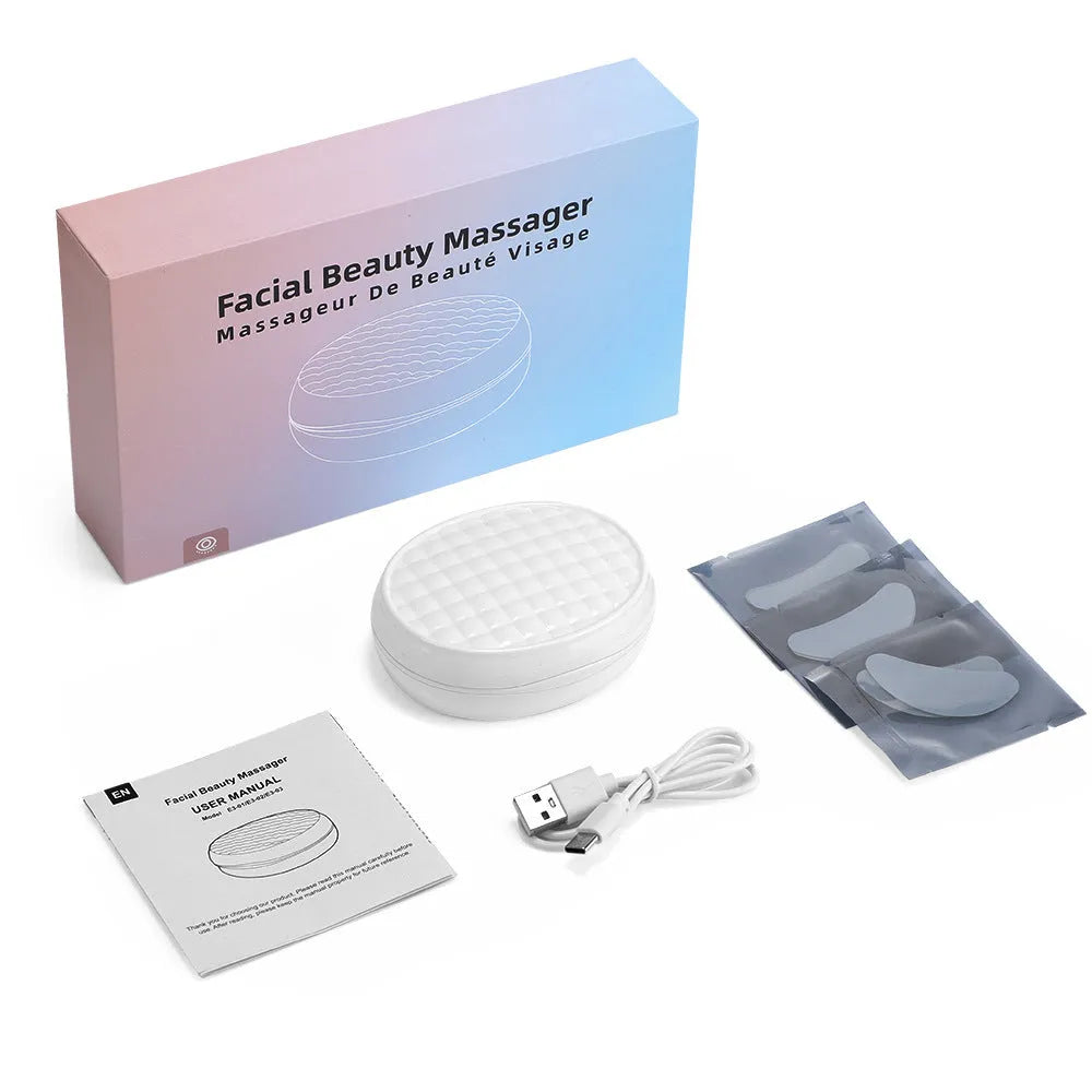White wireless red light EMS eye and facial beauty massager device on a grey background