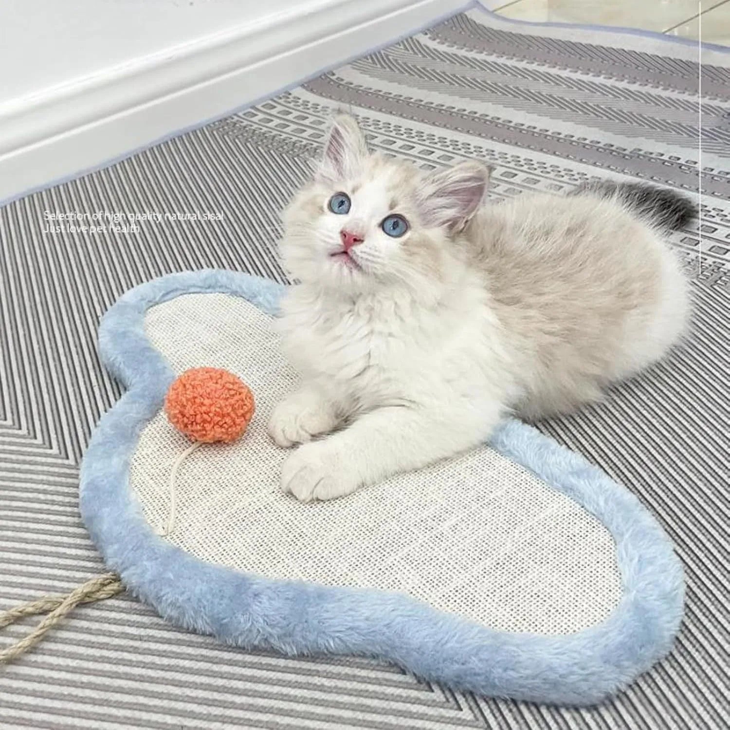 White wall-mounted cat scratching mat with natural sisal surface in a sleeping cat cartoon design.