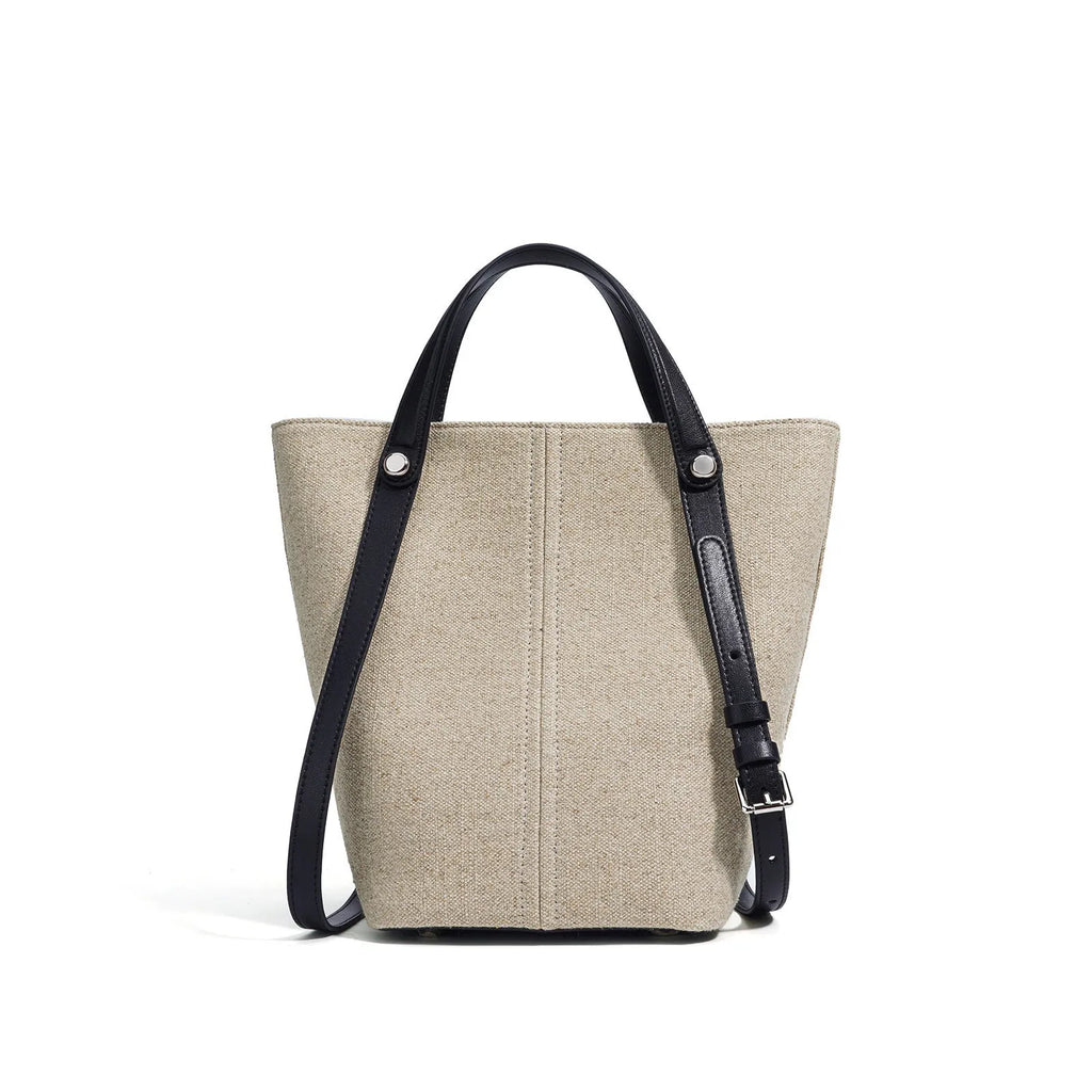 Genuine leather bucket shoulder bag in Linen Black with stitching, open outer pocket, and hand-carry strap