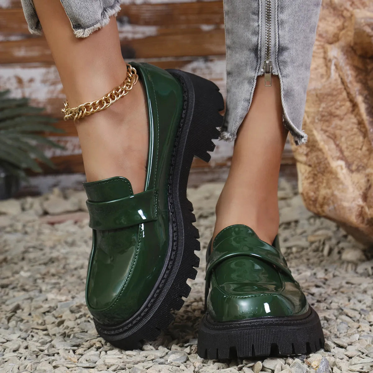 Black chunky heel loafers with a thick rubber sole and platform, shown from the side.
