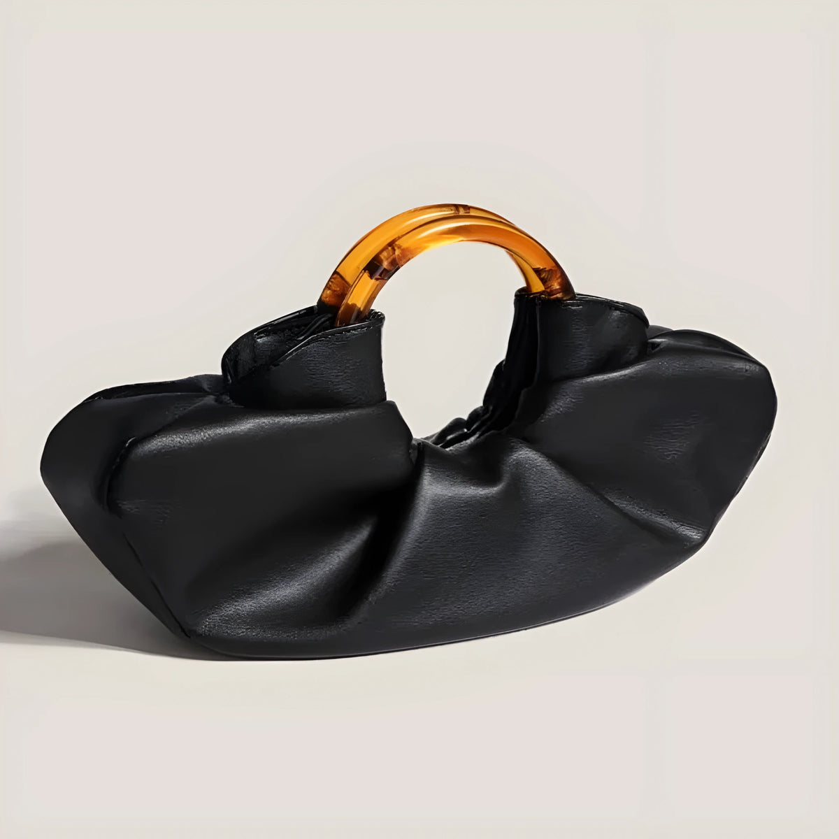 Niche horn bag in black or white PU leather with acrylic ring handle and fold detail for daily matching.