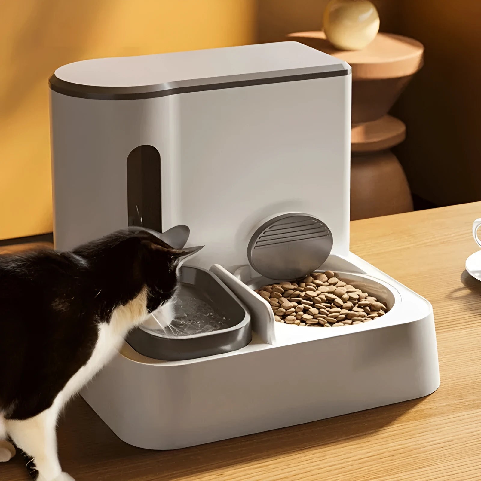 Grey cat automatic feeder and water dispenser station with integrated double bowls.