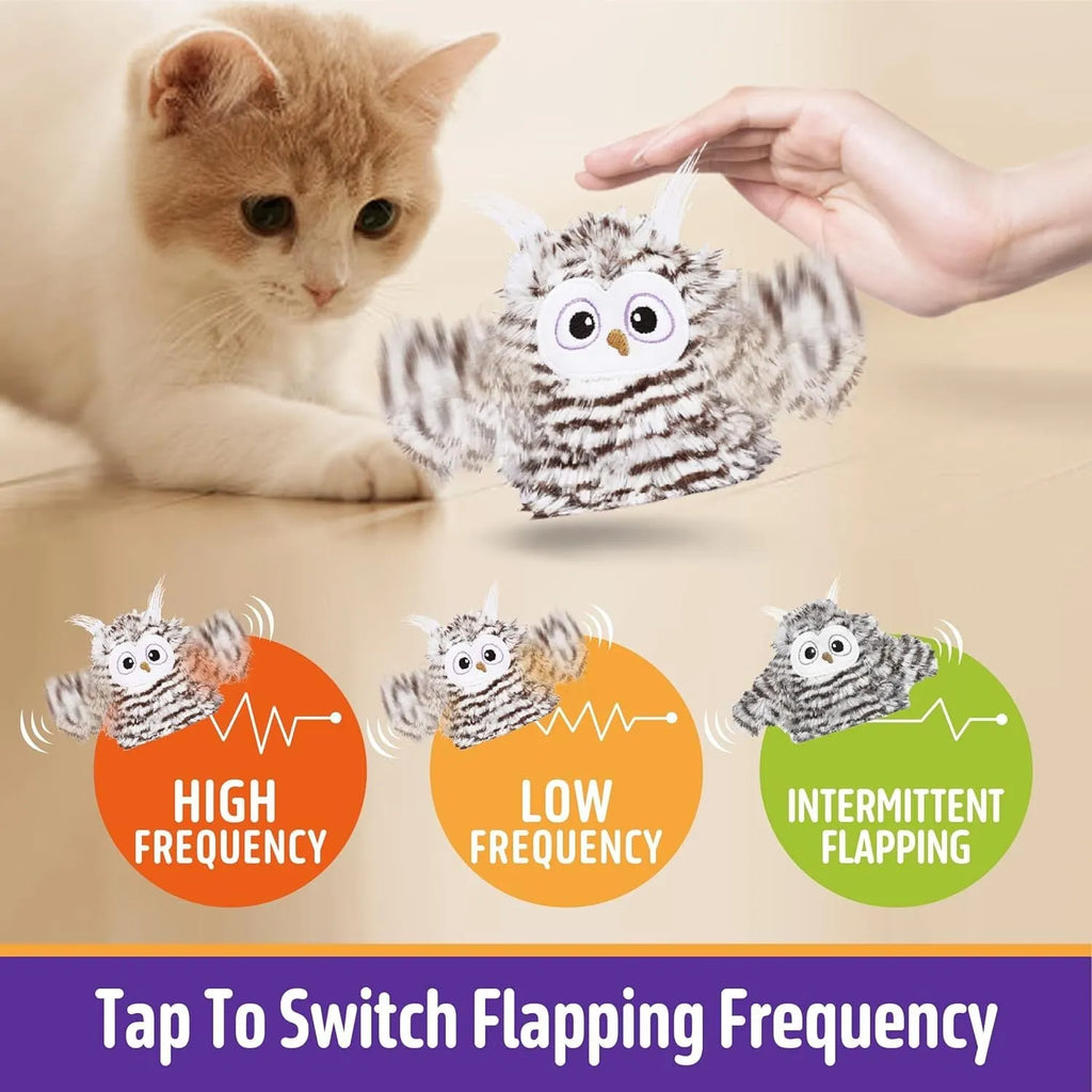 Grey automatic chirping owl cat toy with flapping wings on a floor.
