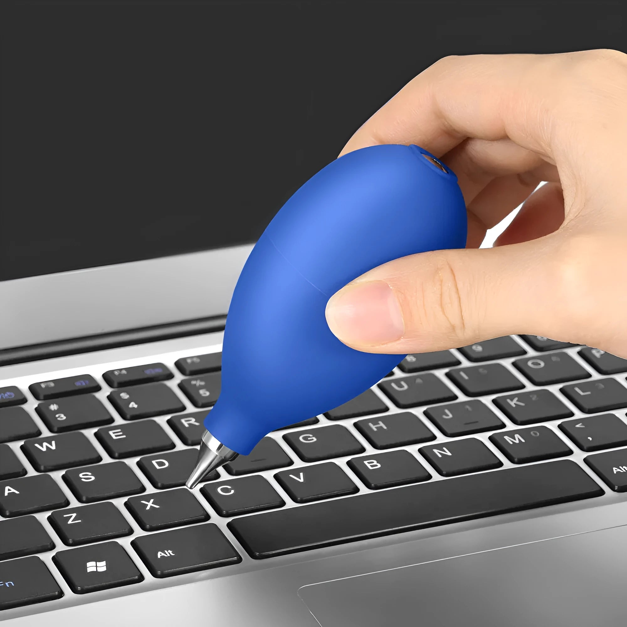 A compact black rubber dust blower with a bulb and nozzle for cleaning cameras and phones.
