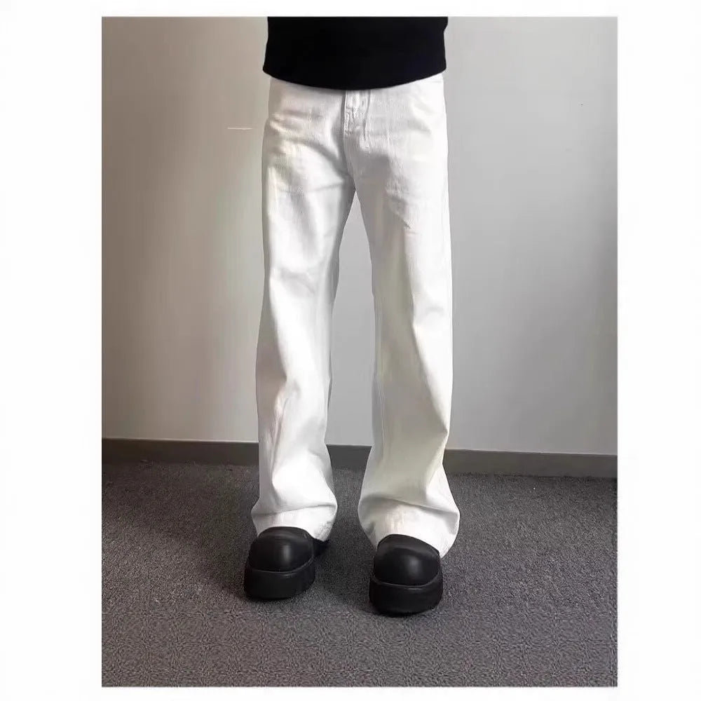 Men's loose straight leg white cotton denim jeans on a hanger.