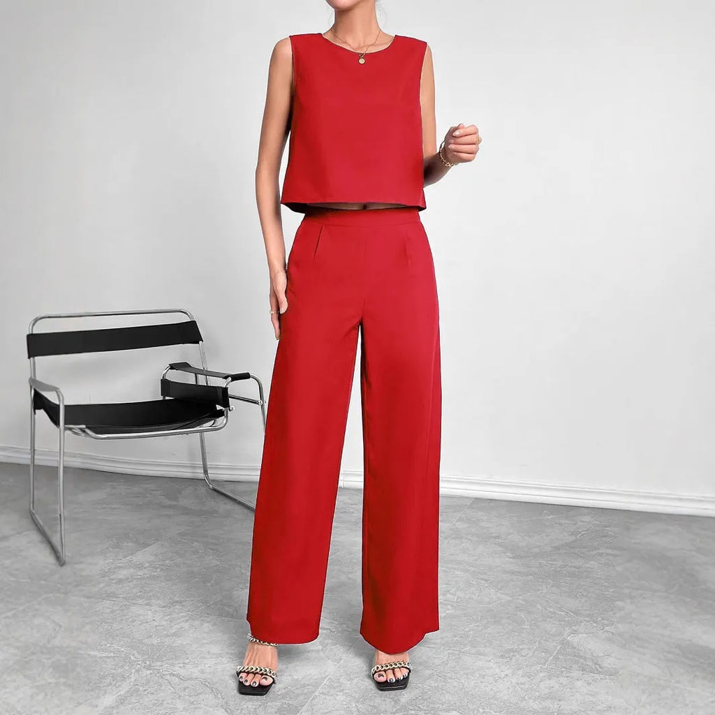 Red women's two-piece set featuring a sleeveless round-neck top and matching wide-leg trousers on a hanger.