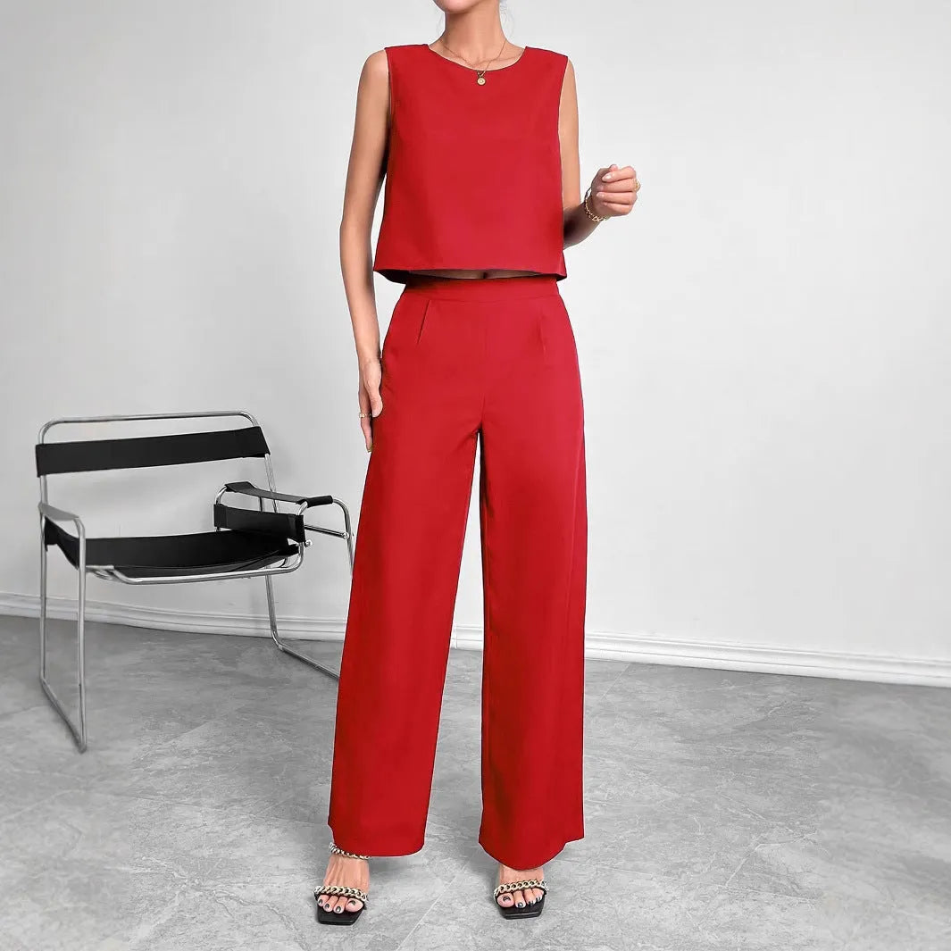 Red women's two-piece set featuring a sleeveless round-neck top and matching wide-leg trousers on a hanger.