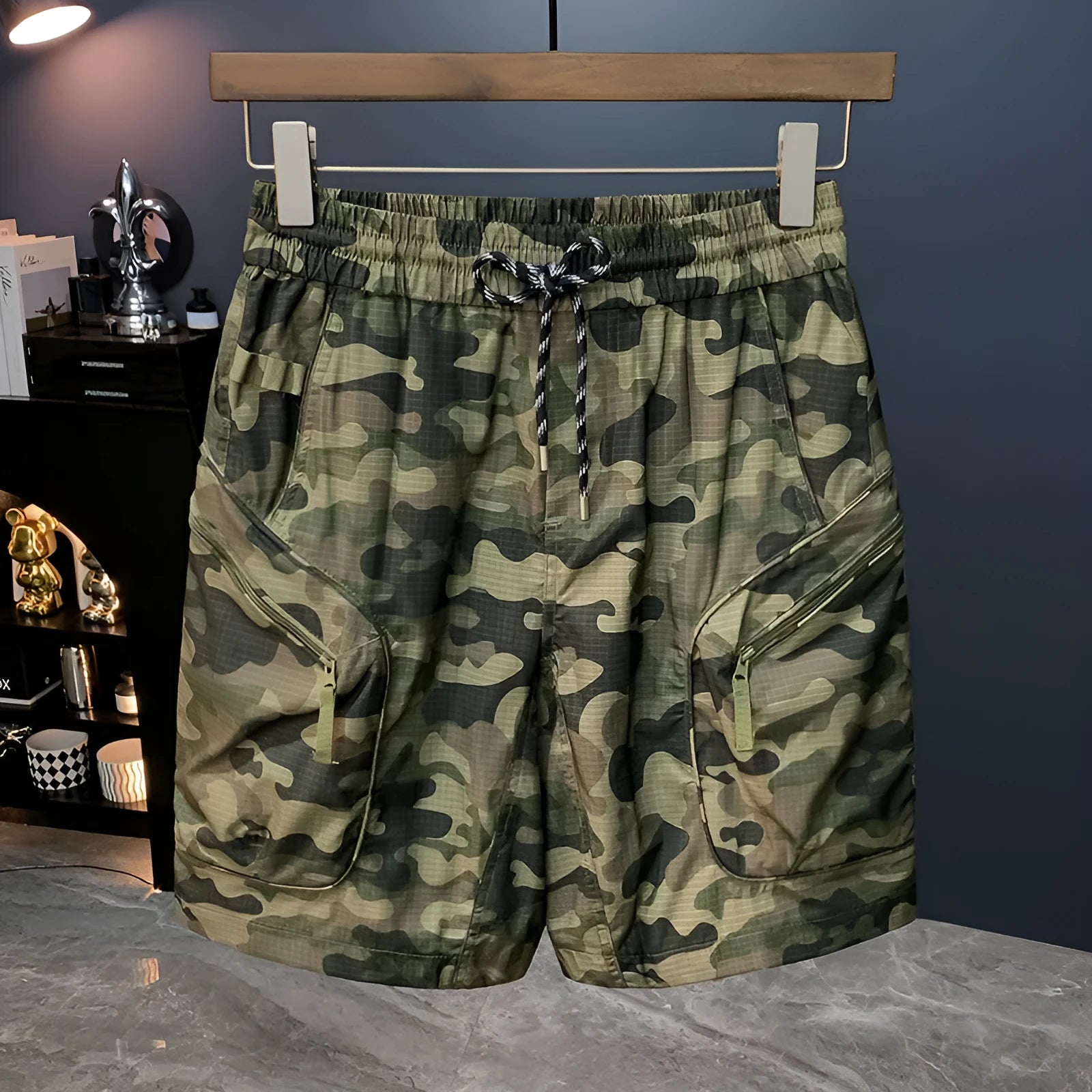 Men's camouflage pattern loose-fit cotton blend cargo shorts on a hanger