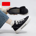 Men's canvas skate shoes in beige with cross straps and a low platform heel on a grey background