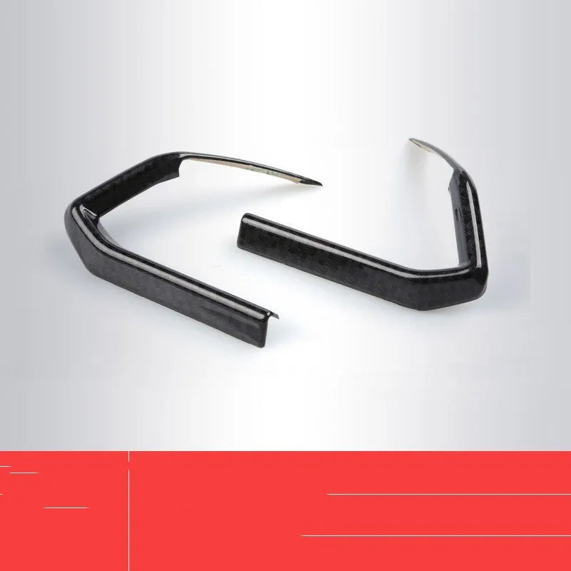 A pair of carbon fibre style ABS plastic steering wheel frames for non-destructive adhesive installation.