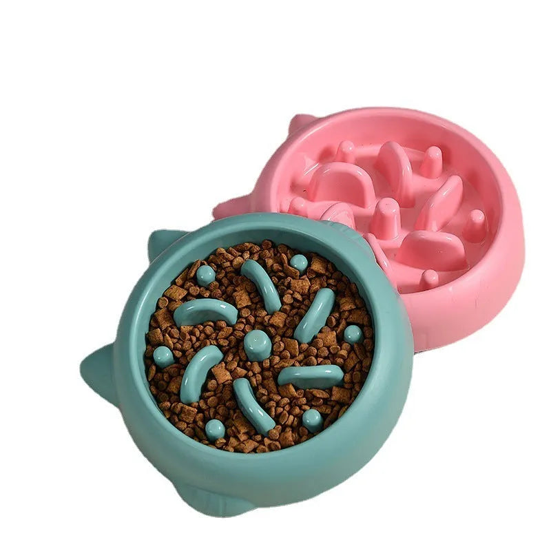 Bone-shaped slow feeder dog bowl with maze pattern in green, pink, or orange colours